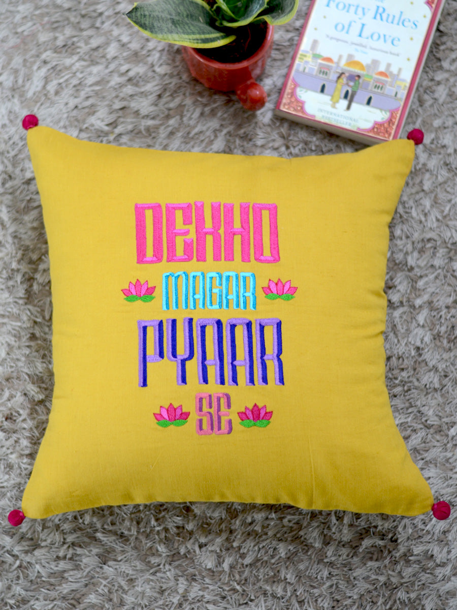 Dekho Magar Pyaar Se Cushion Cover, a hand embroidered cotton cushion cover with pom pom detailing from our wide range of quirky, bohemian home decor products like ethnic cushion covers, thread art, wall decor and more.